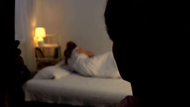Woman looking at husband with mistress in bed, finding out adultery, crisis
